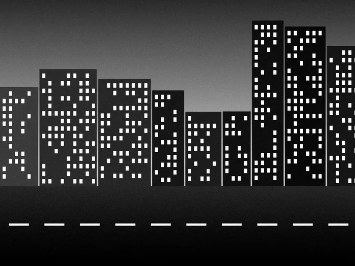 The city street at dusk in black and white, with a little more contrast.