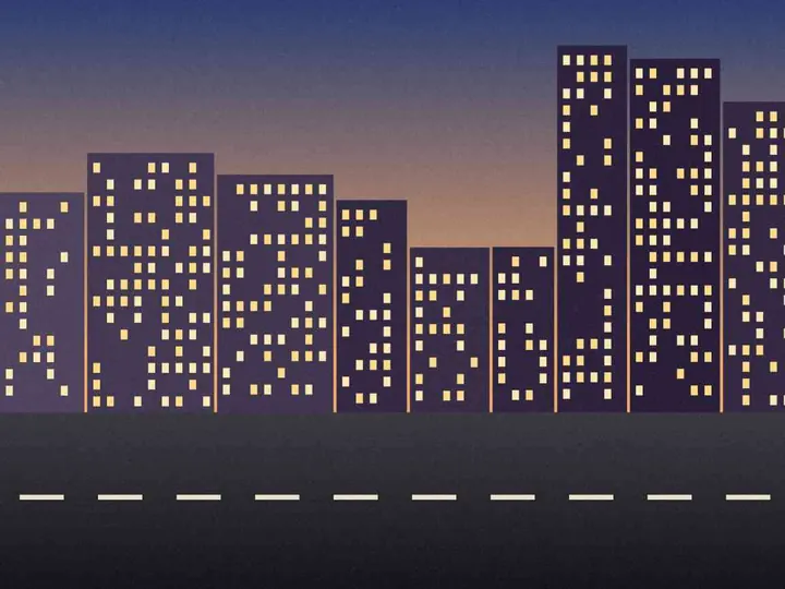 The same city street at dusk, saved smaller as a JPEG under 50 KB.