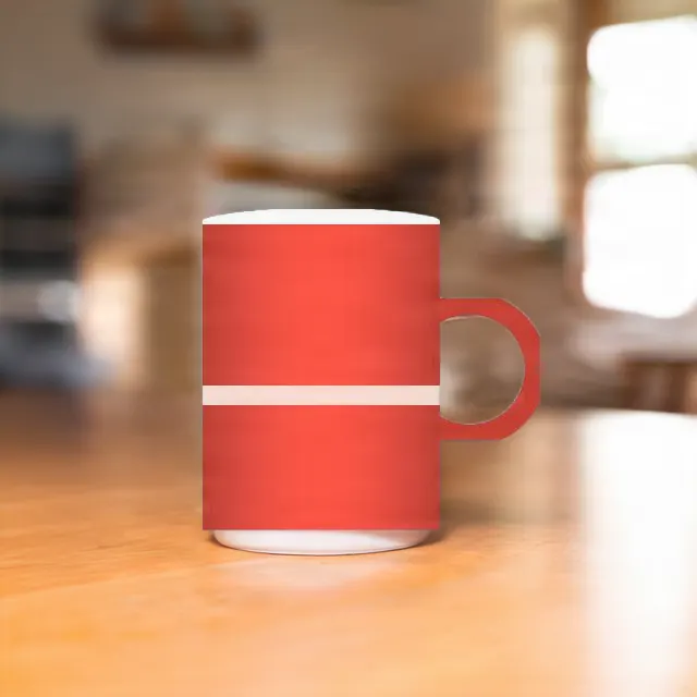 The red mug on a wooden table in a softly blurred café, its studio backdrop replaced.